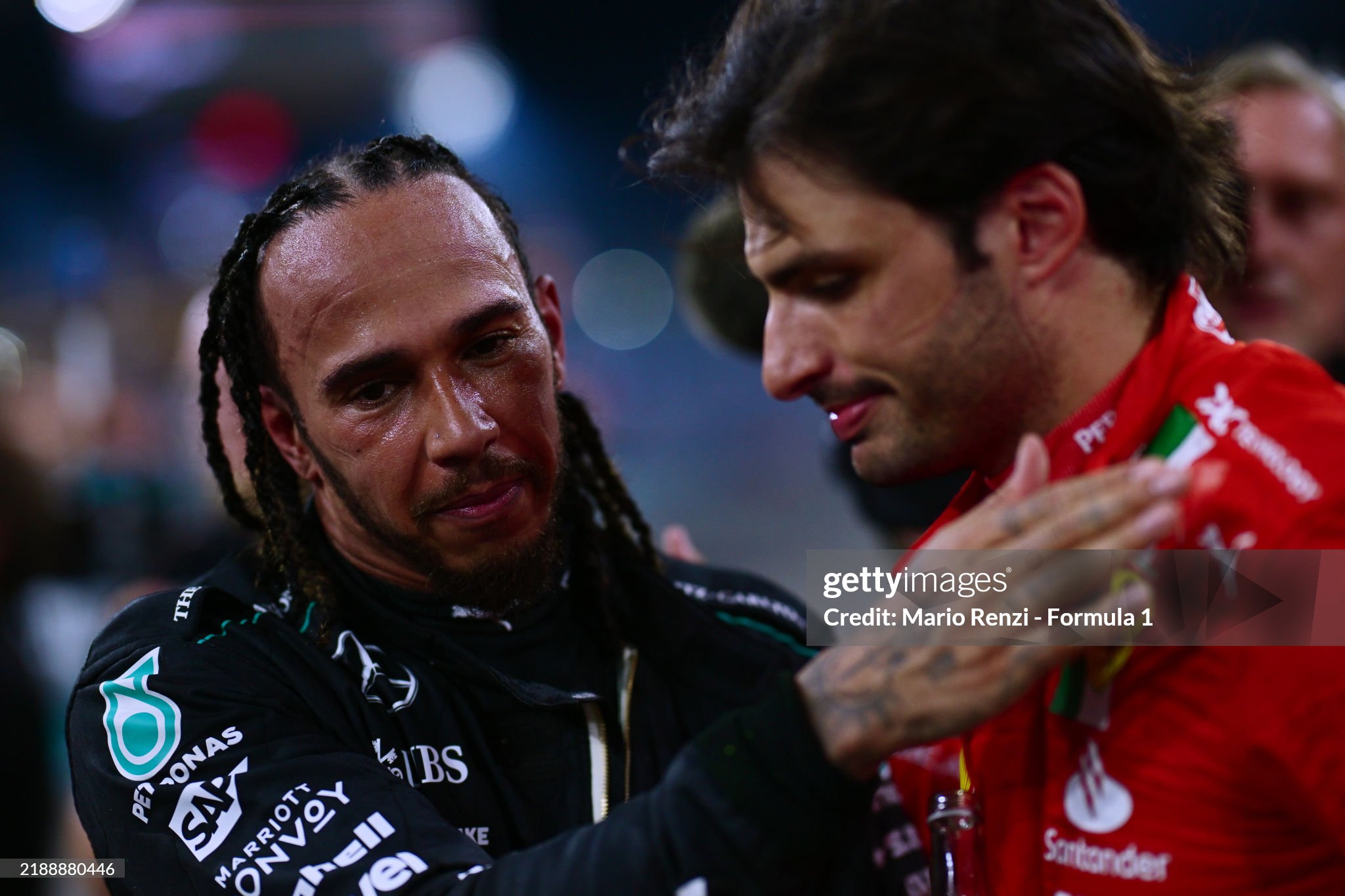 4th placed Lewis Hamilton of Great Britain and Mercedes talks with second placed Carlos Sainz of Spain and Ferrari in parc ferme after the F1 Grand Prix of Abu Dhabi at Yas Marina Circuit on December 08, 2024. 