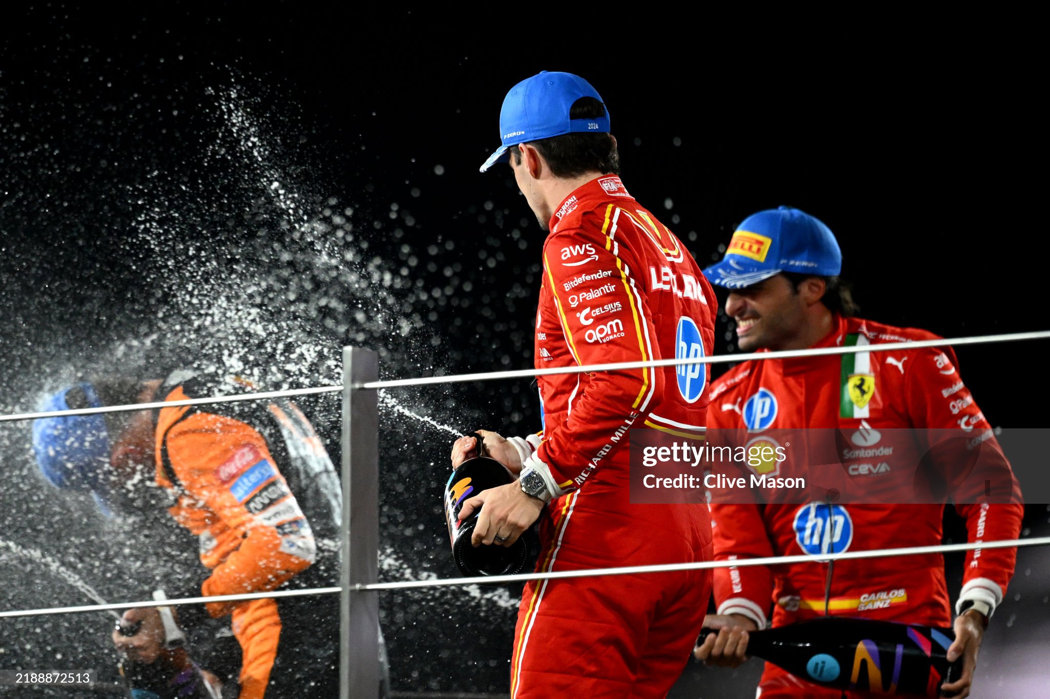 Race winner Lando Norris of Great Britain and McLaren, second placed Carlos Sainz of Spain and Ferrari and third placed Charles Leclerc of Monaco and Ferrari celebrate on the podium after the F1 Grand Prix of Abu Dhabi at Yas Marina Circuit on December 08, 2024. 