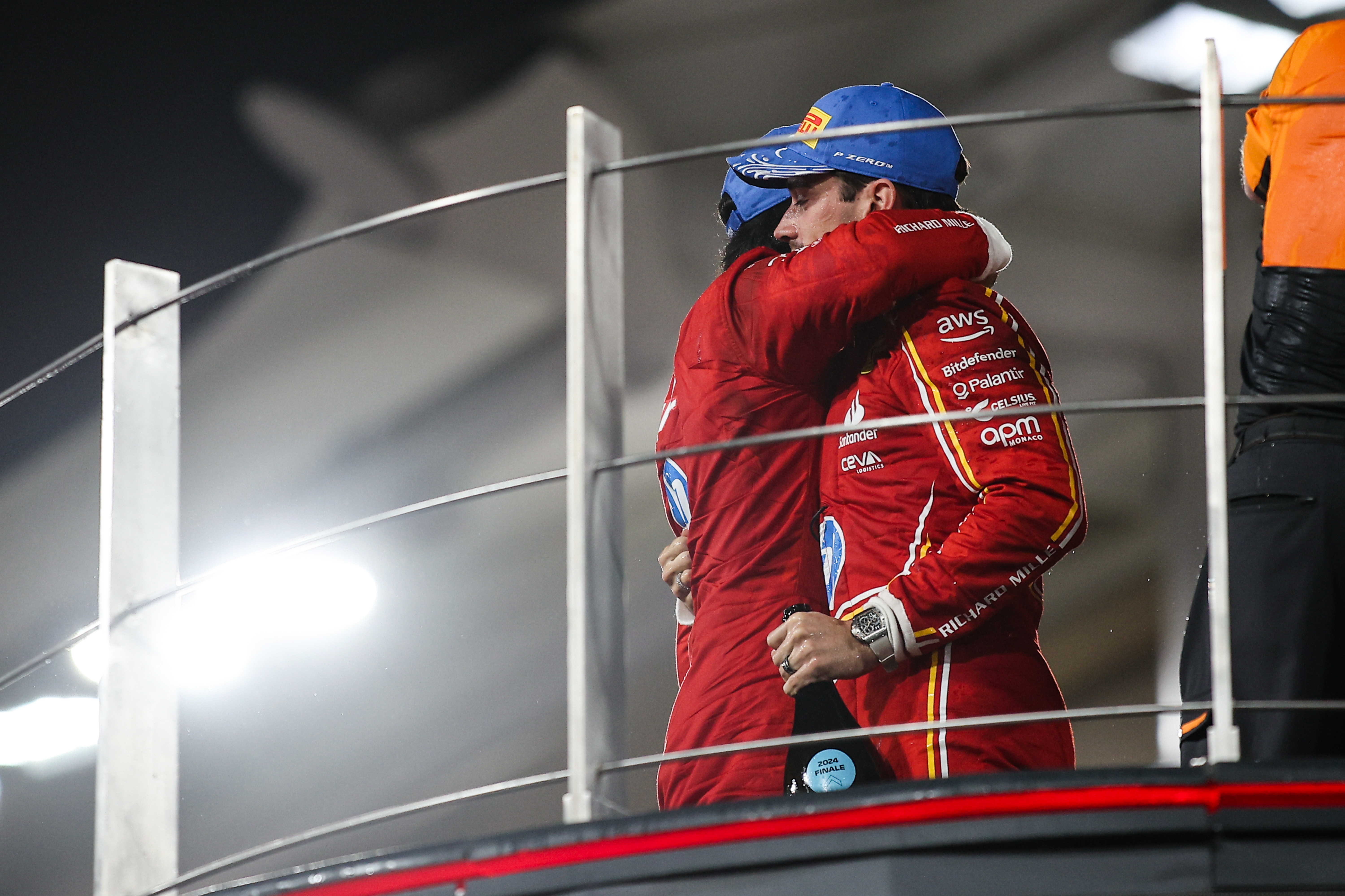 Carlos Sainz and Charles Leclerc embrace on the podium of the Abu Dhabi Grand Prix on December 08, 2024.