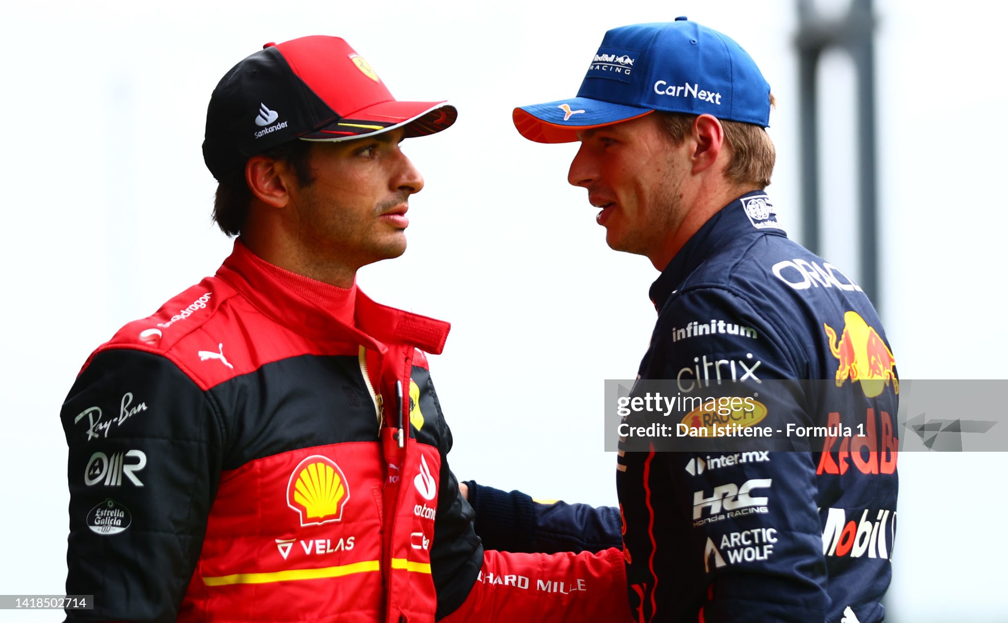 Pole position qualifier Max Verstappen of the Netherlands and Red Bull Racing and second placed qualifier Carlos Sainz of Spain and Ferrari talk in parc ferme during qualifying ahead of the F1 Grand Prix of Belgium at Circuit de Spa-Francorchamps on August 27, 2022. 