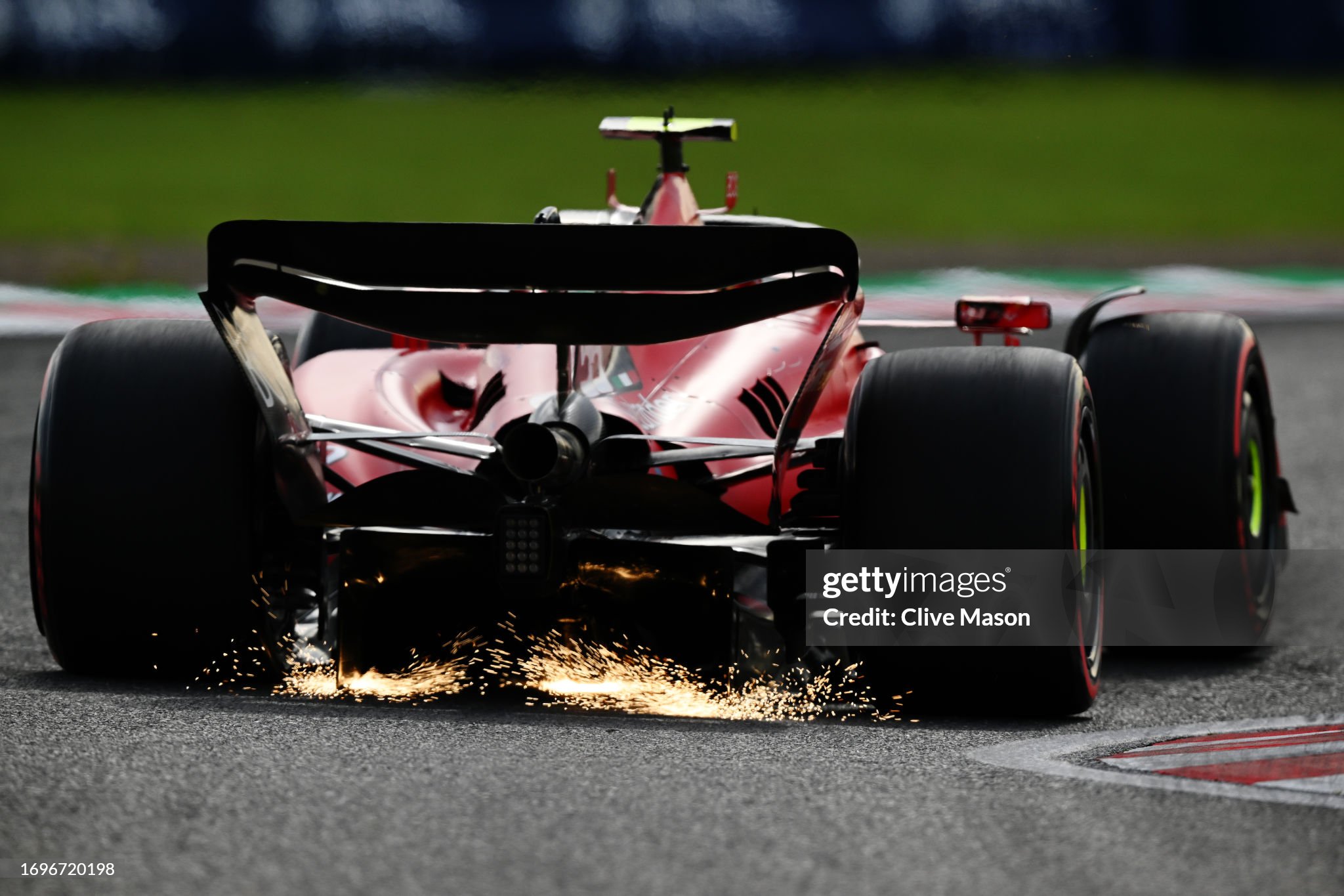 Sparks fly from the rear of Carlos Sainz of Spain driving the Ferrari SF-23 on track during qualifying ahead of the F1 Grand Prix of Japan at Suzuka International Racing Course on September 23, 2023. 