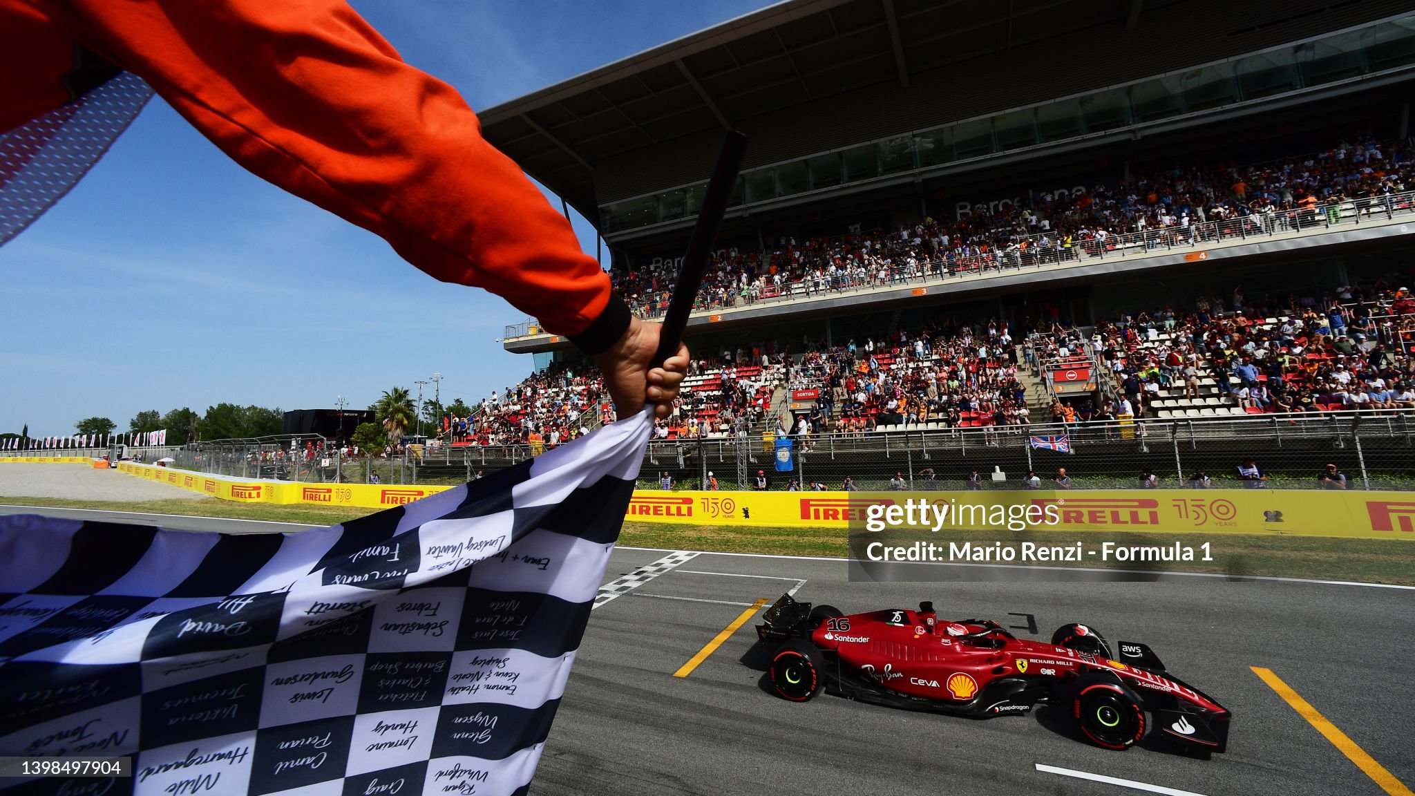 Pole position qualifier Charles Leclerc driving the Ferrari F1-75 takes the chequered flag during qualifying ahead of the F1 Grand Prix of Spain at Circuit de Barcelona-Catalunya on 21 May 2022. 