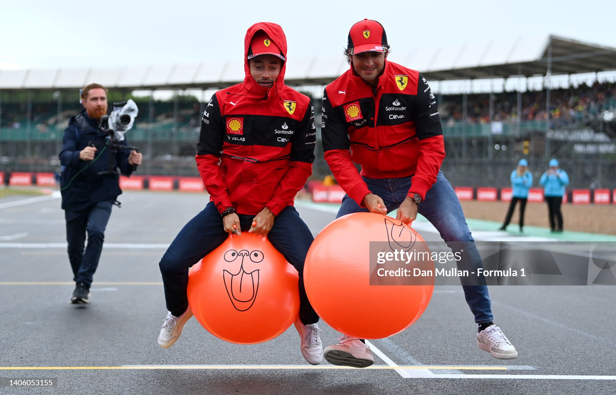 Carlos Sainz and Charles Leclerc race space hoppers on the grid during previews ahead of the F1 Grand Prix of Great Britain at Silverstone on June 30, 2022. 