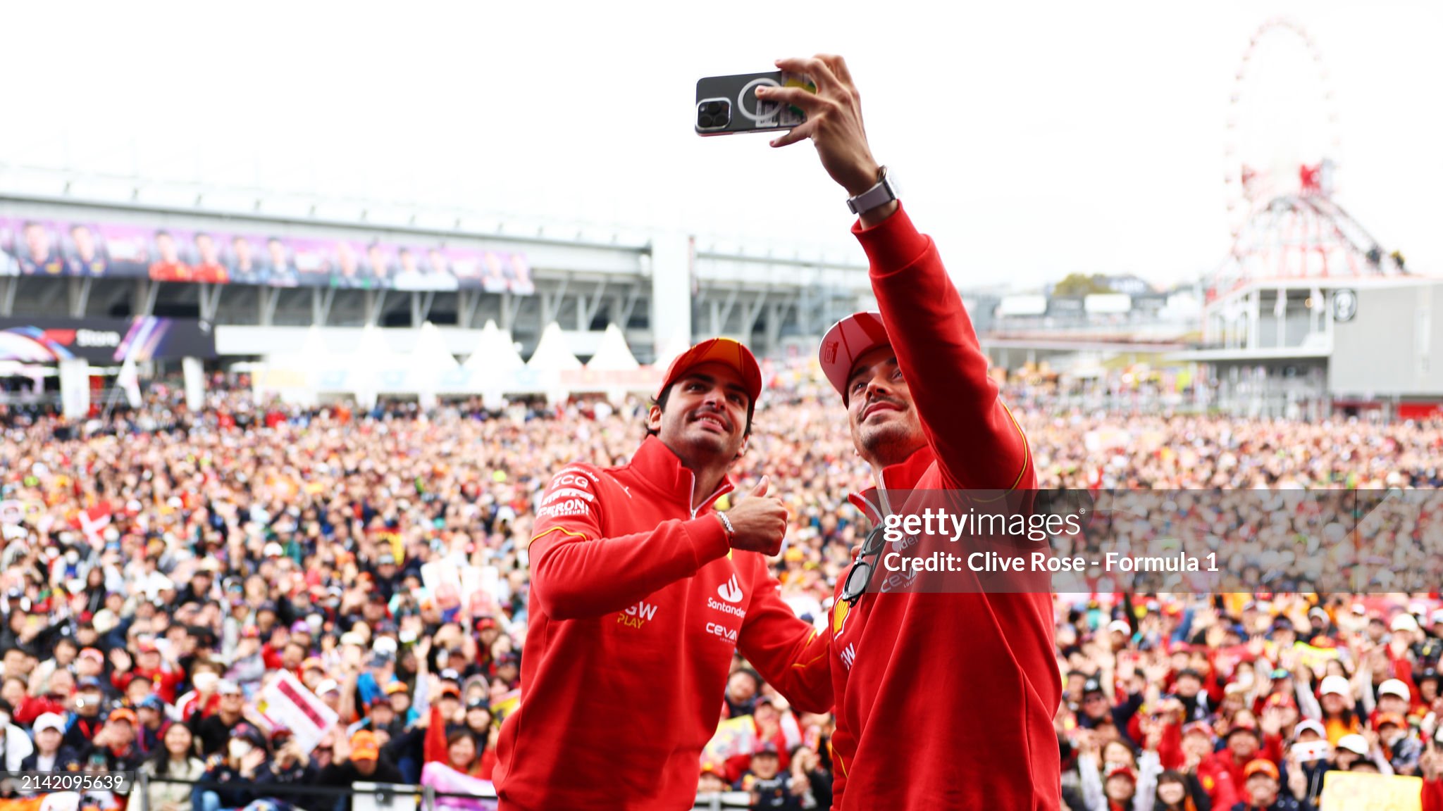 Carlos Sainz of Spain and Ferrari and Charles Leclerc of Monaco and Ferrari take a photo on the fan stage prior to final practice ahead of the F1 Grand Prix of Japan at Suzuka International Racing Course on April 06, 2024. 