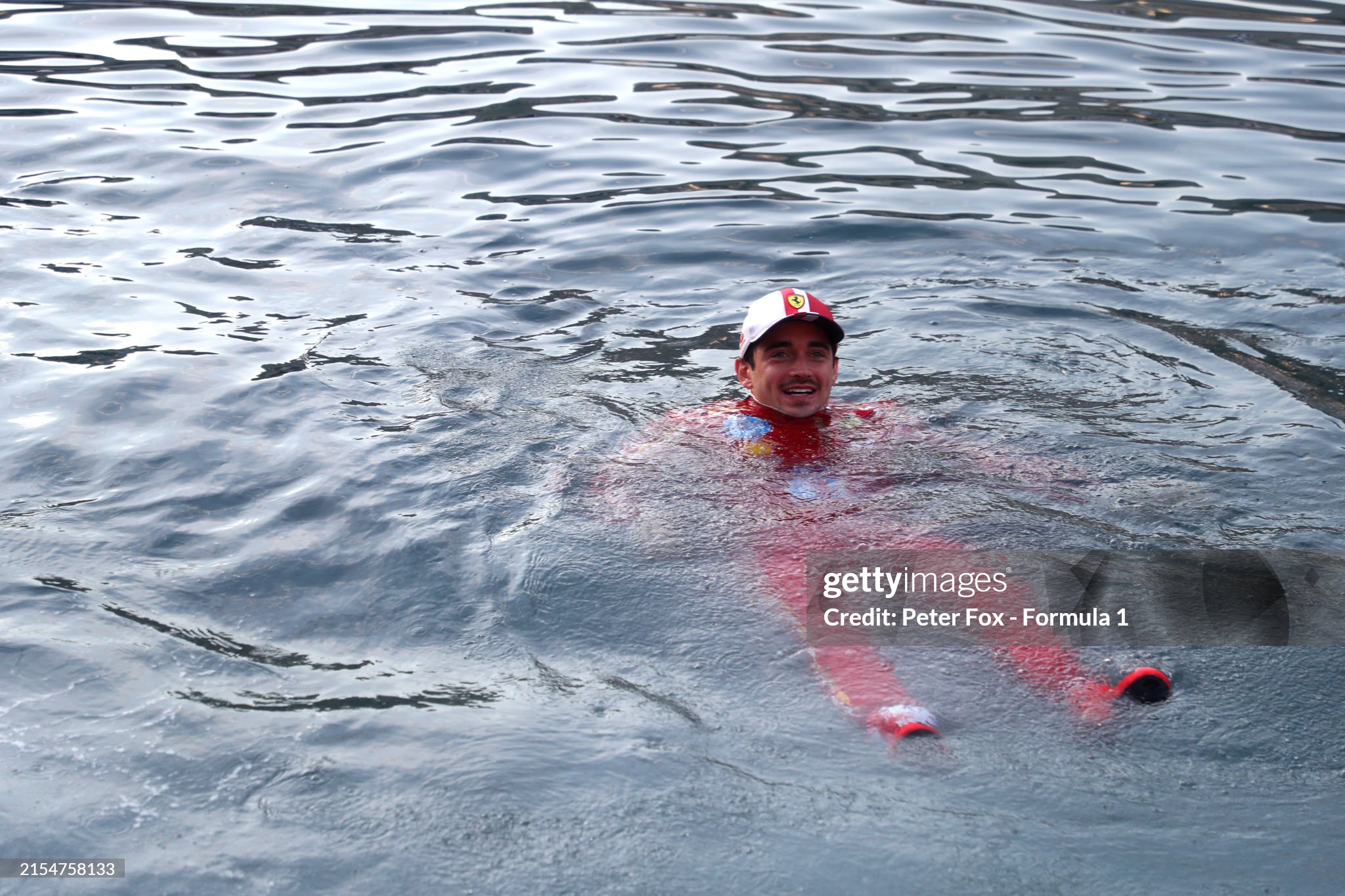 Race winner Charles Leclerc of Monaco and Ferrari celebrates by jumping in the harbour after the F1 Grand Prix of Monaco at Circuit de Monaco on May 26, 2024. 