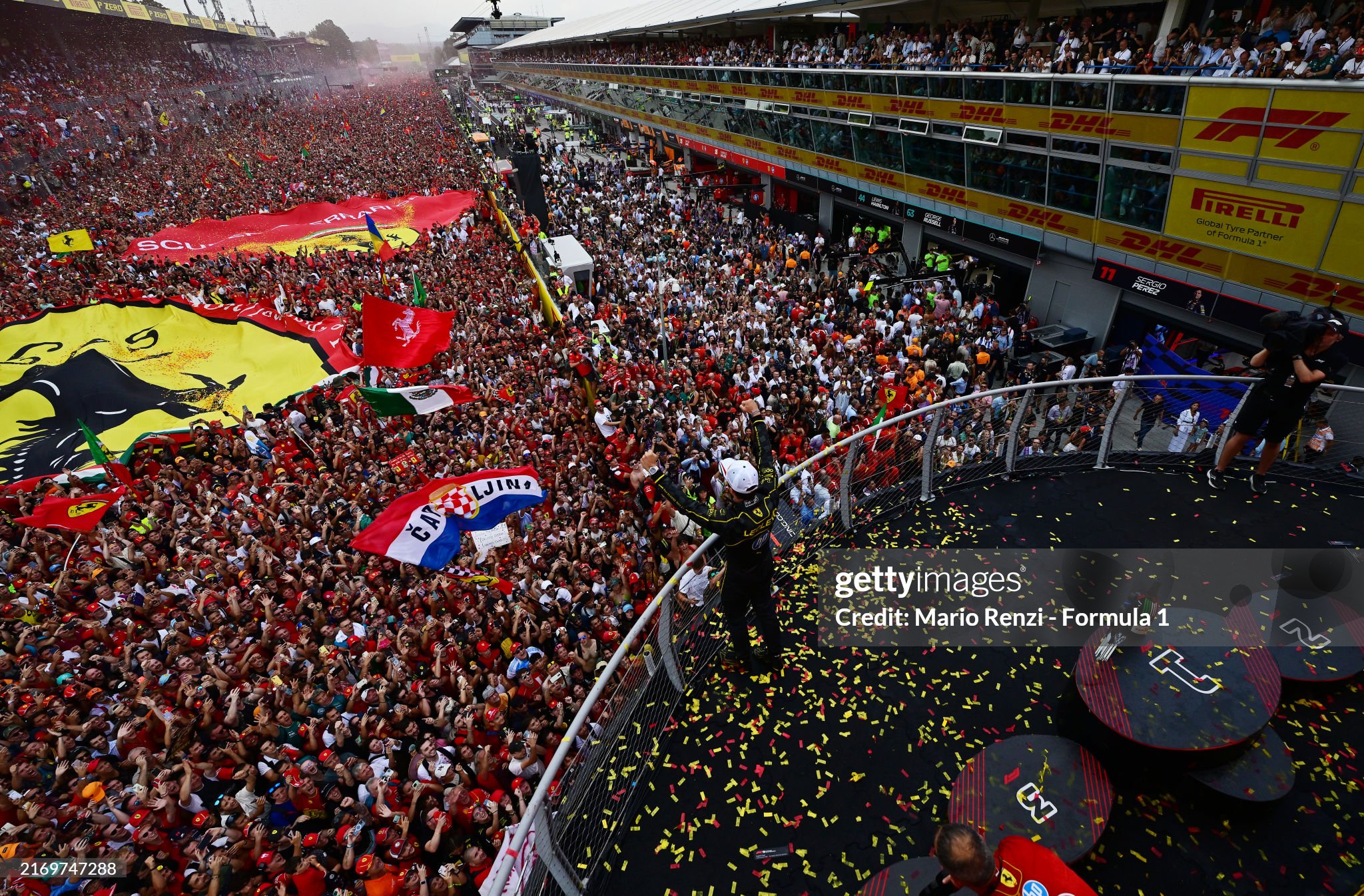 A general view showing race winner Charles Leclerc waving to fans from the podium after the F1 Grand Prix of Italy at Autodromo Nazionale Monza on September 01, 2024. 