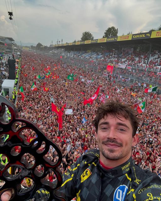 Charles Leclerc takes a selfie with fans after the 2024 Monza Grand Prix.