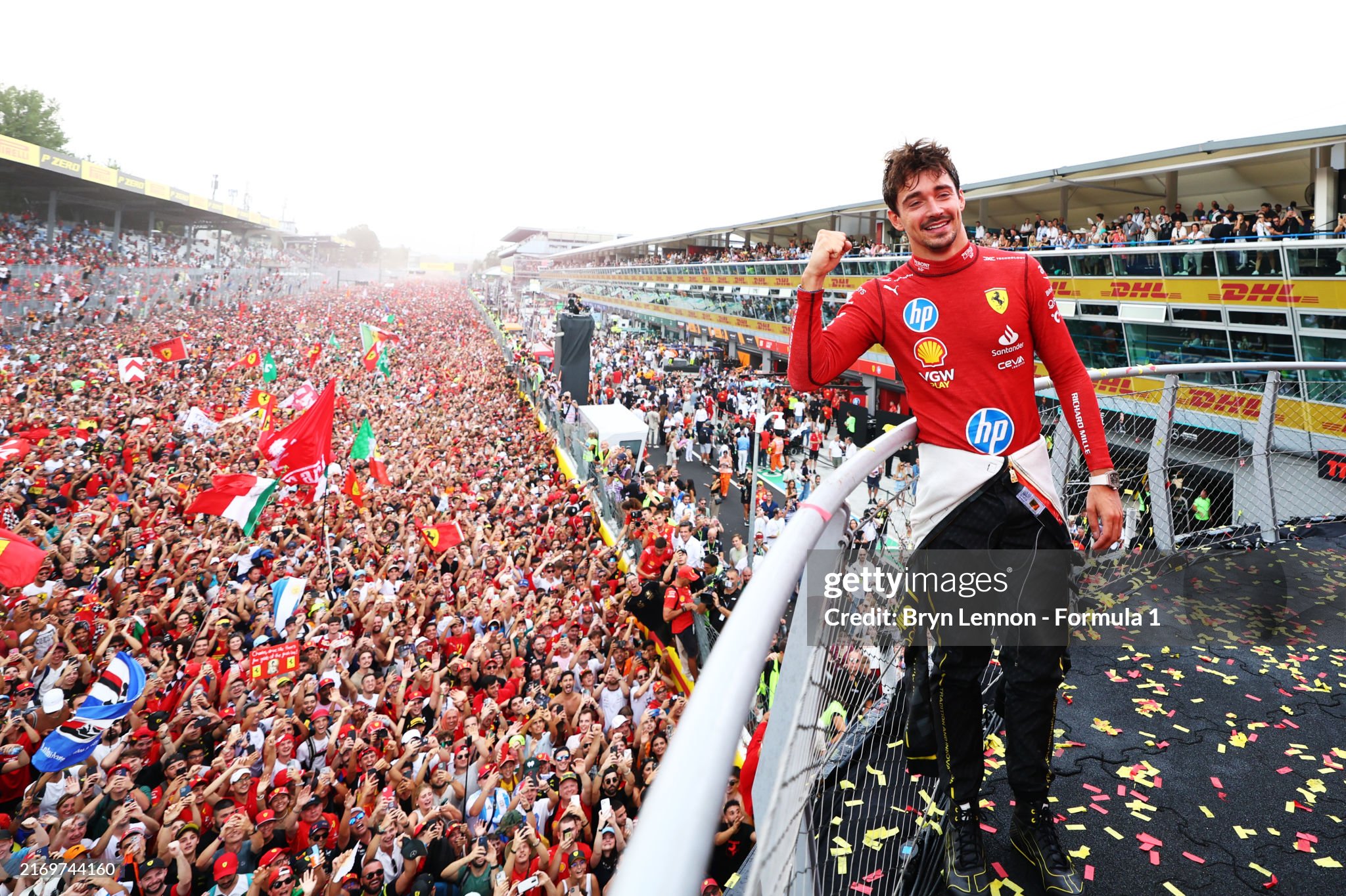 Race winner Charles Leclerc poses for a picture on the podium with the fans down on the track after the F1 Grand Prix of Italy at Autodromo Nazionale Monza on September 01, 2024. 