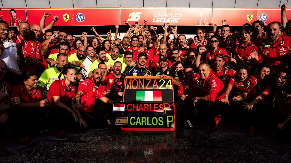 Charles Leclerc in a group photo with his team after his victory at the 2024 Monza Grand Prix.