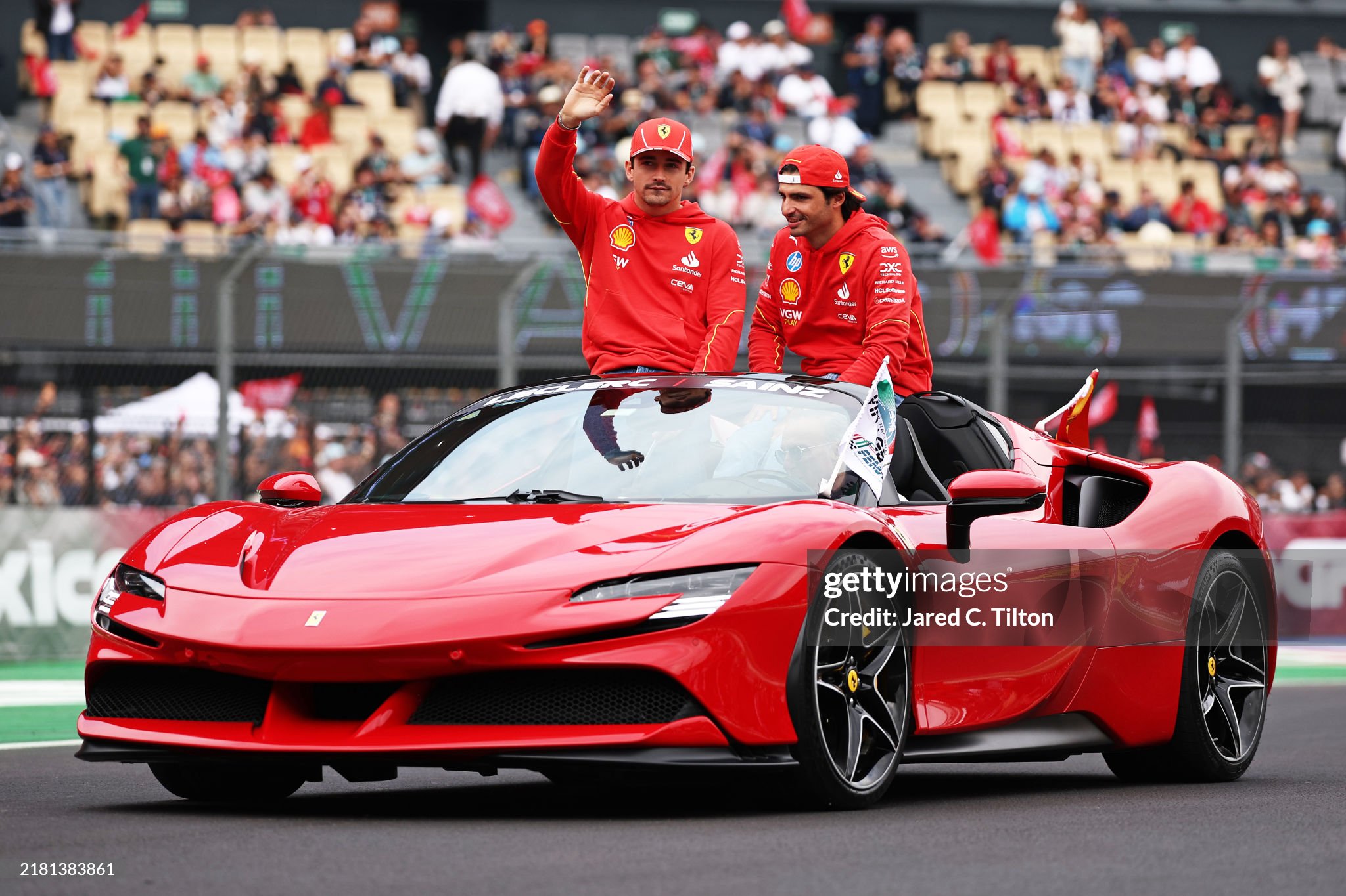 Carlos Sainz of Spain and Ferrari and Charles Leclerc of Monaco and Ferrari wave to the crowd at the drivers parade prior to the F1 Grand Prix of Mexico at Autodromo Hermanos Rodriguez on October 27, 2024. 