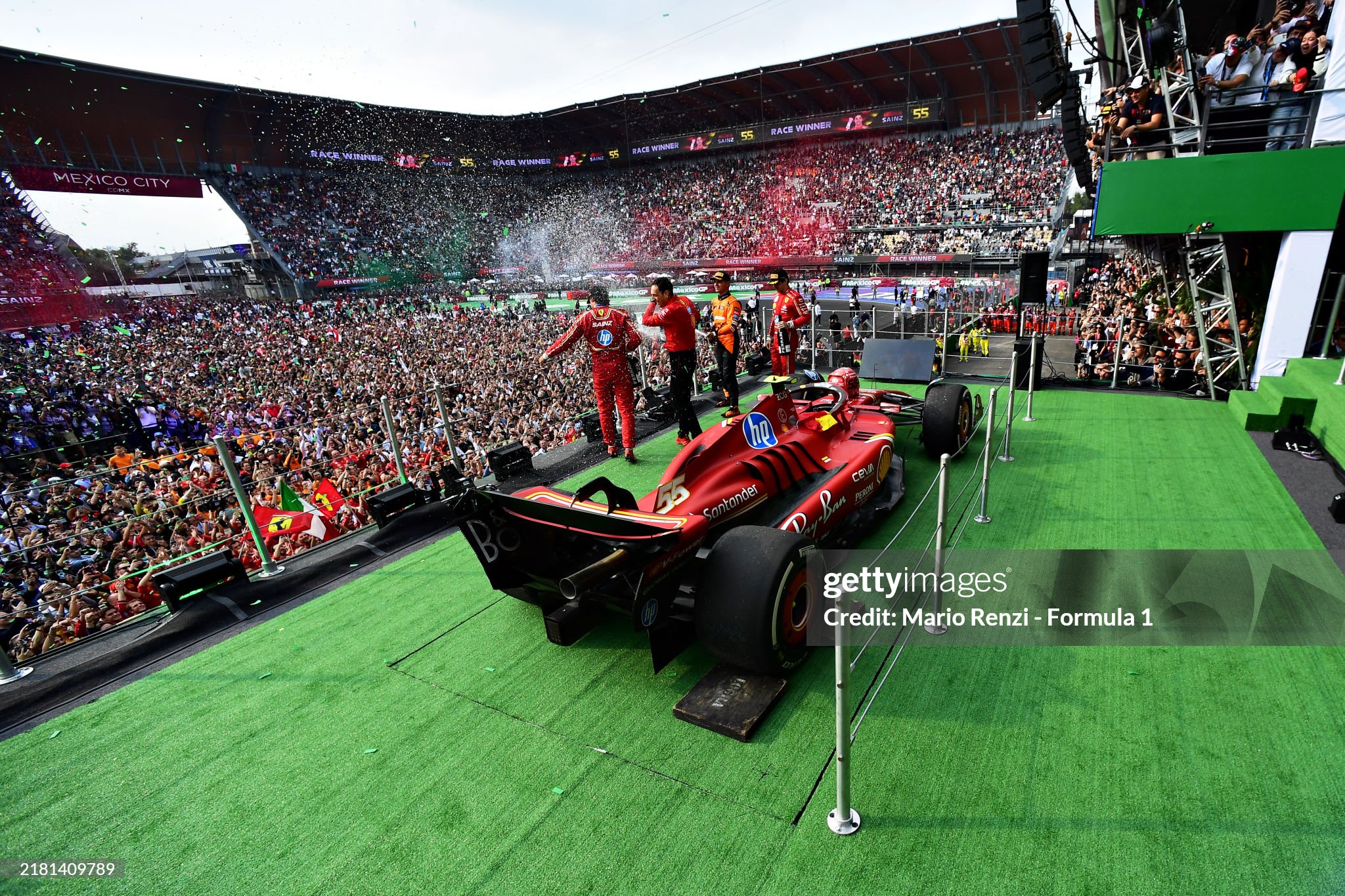 Race winner Carlos Sainz, second placed Lando Norris and third placed Charles Leclerc celebrate on the podium after the F1 Grand Prix of Mexico at Autodromo Hermanos Rodriguez on October 27, 2024. 