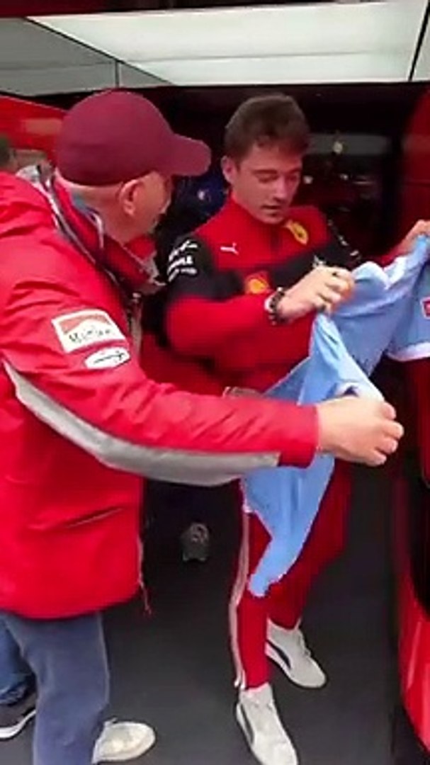 Charles Leclerc receives the Lazio jersey at Imola in 2022.