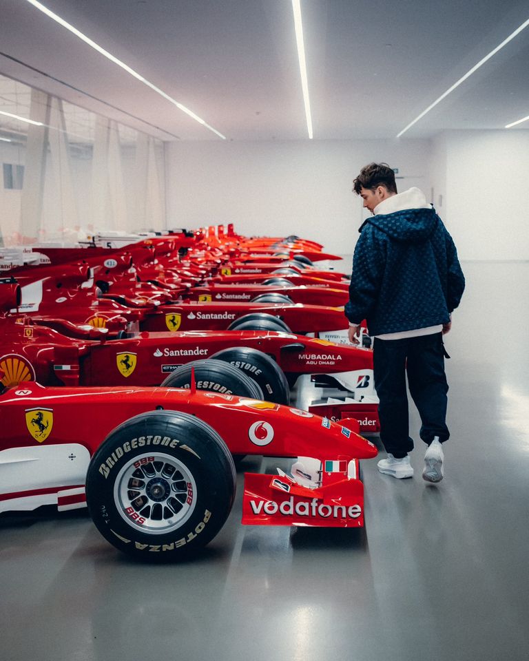 Charles Leclerc and some vintage Ferrari Formula 1 cars.