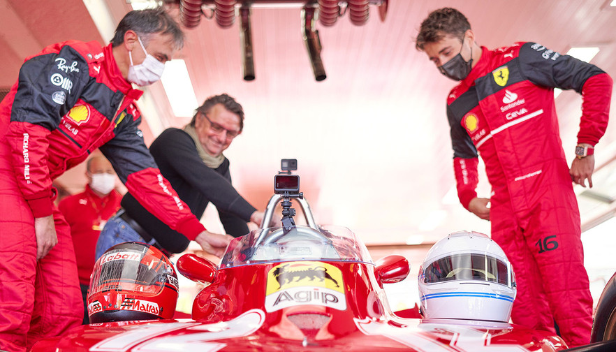 Charles Leclerc and Réne Arnoux discuss in the garage Villeneuve's 312 T4.