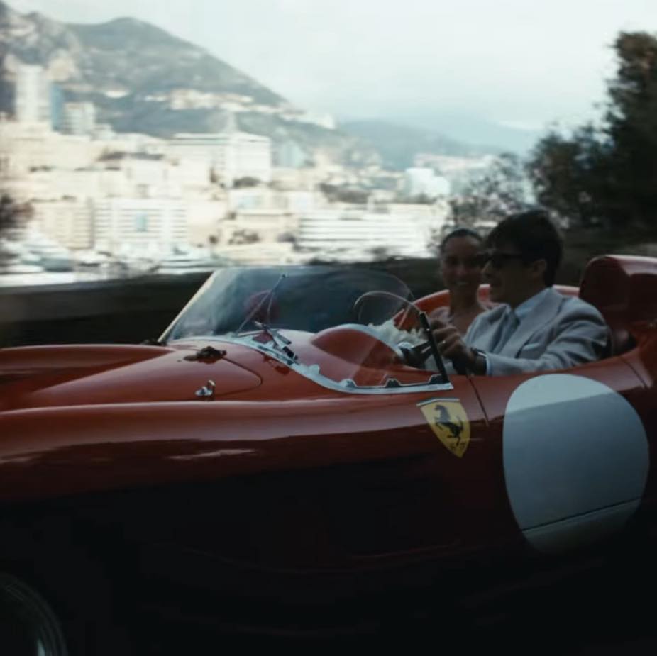 Charles and Alexandra riding together in a striking vintage red Ferrari 250 Testa Rossa.