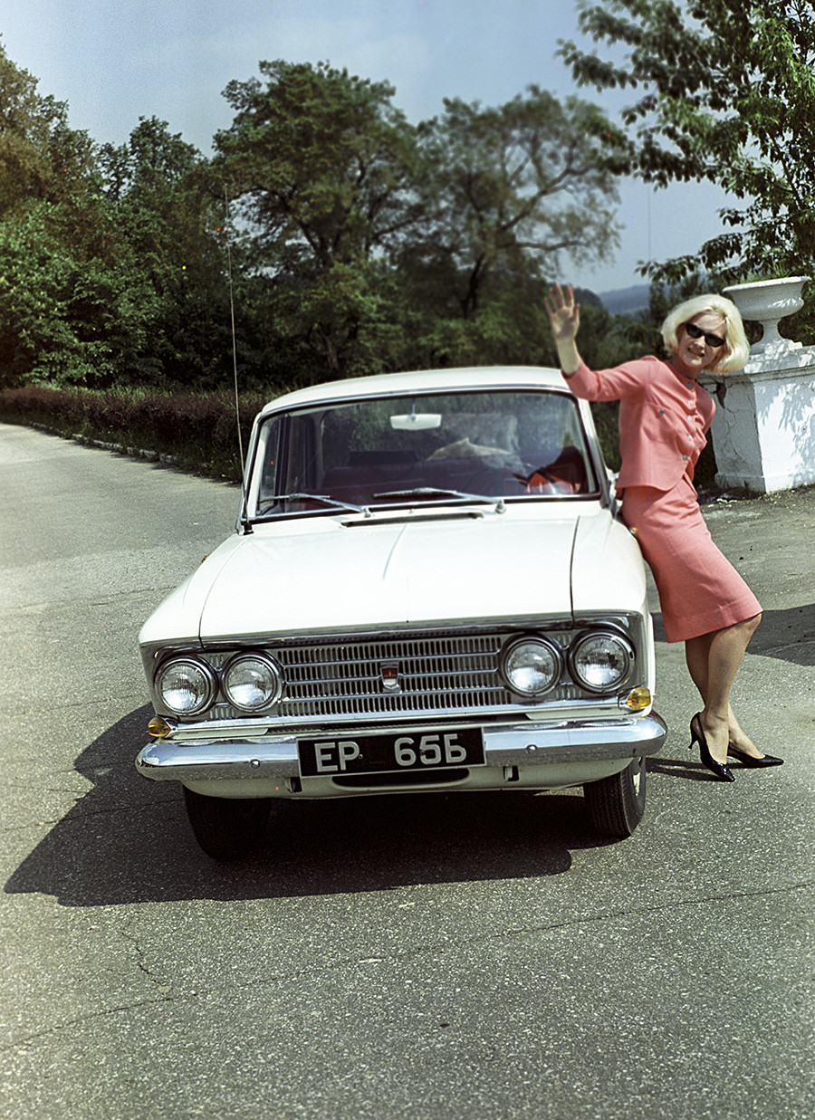 A Russian lady and a white Moskvitch 408 in 1965.