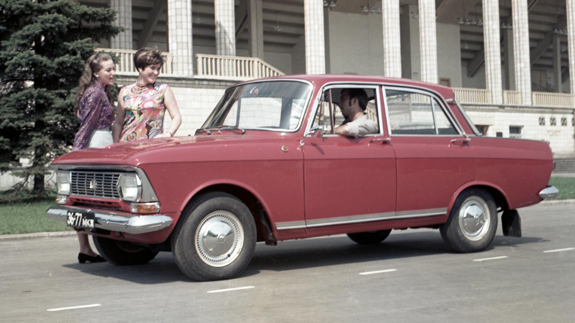 A man, two girls and a red Moskvitch in 1972.