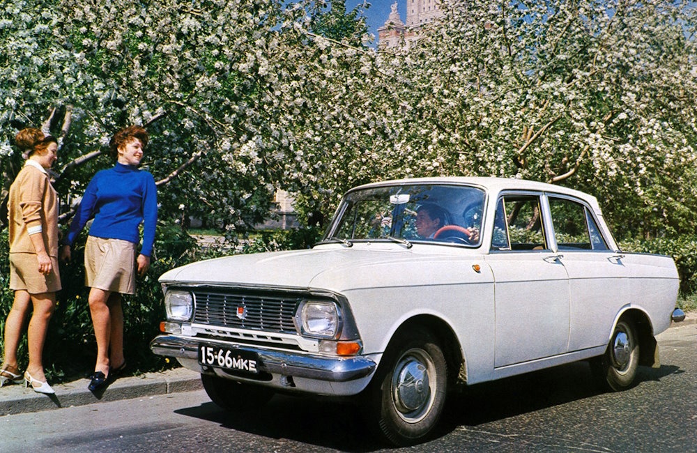 A man, two girls and a white Moskvitch.