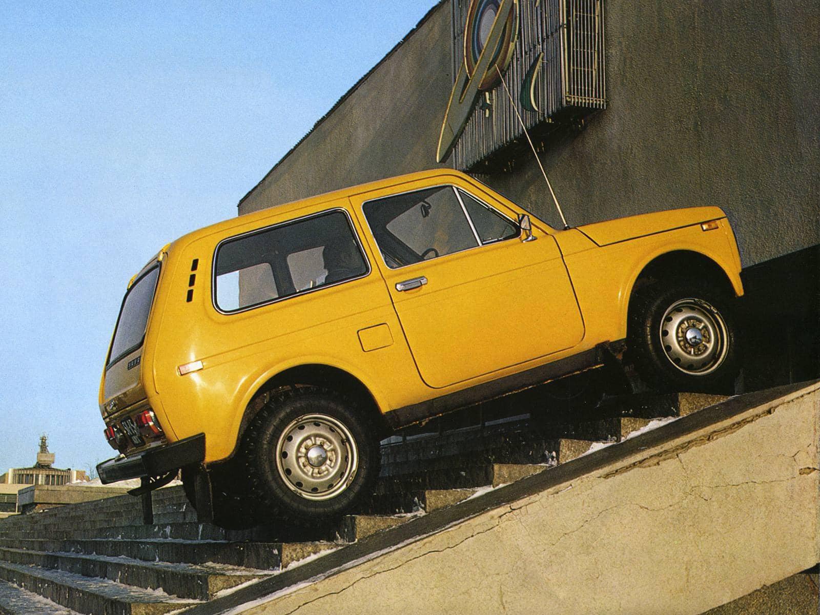 A yellow Lada Niva climbing the stairs.