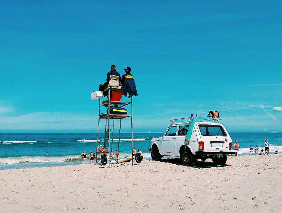 A white Lada Niva on the beach.