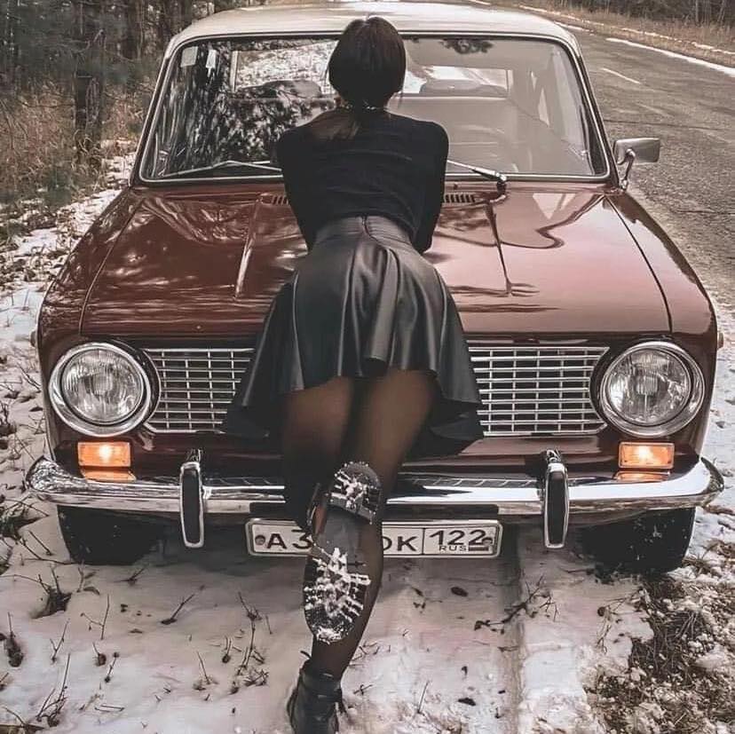 A girl and a violet Russian Lada.