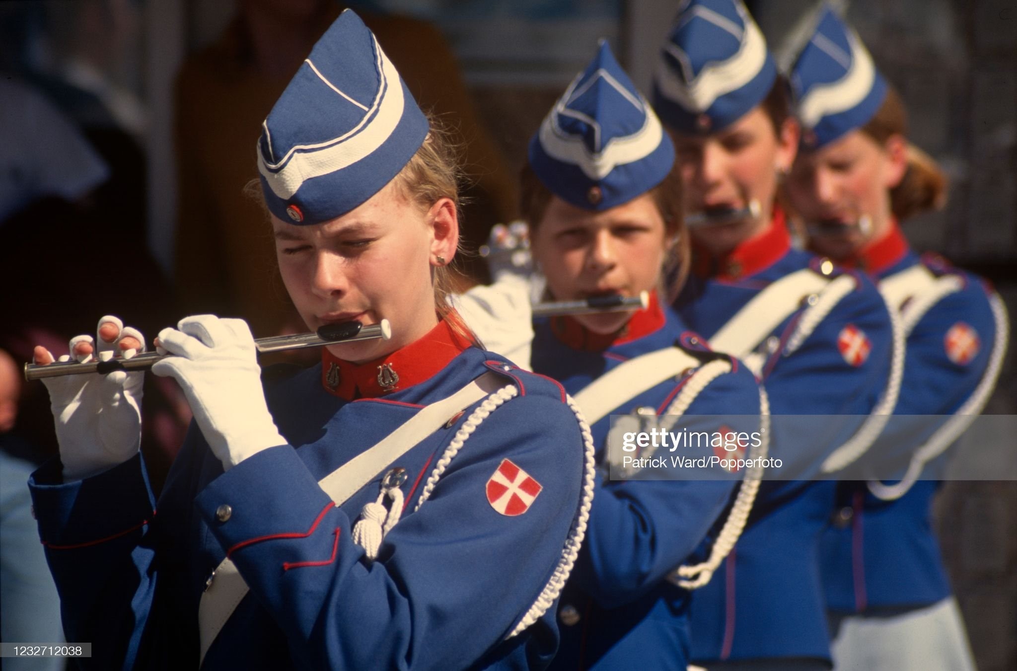 Young women playing fifes, a small flute, in a marching band in Akureyri, Iceland, circa June 1988.