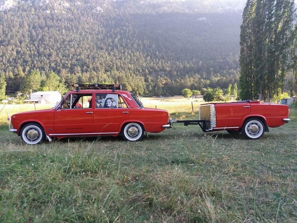 A red Zhiguli with its trailer.