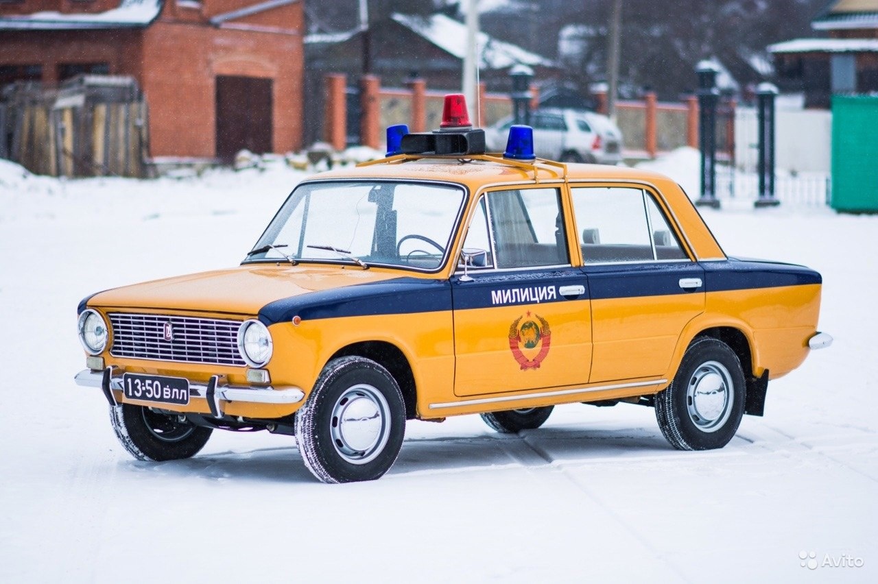 An orange Zhiguli police car.