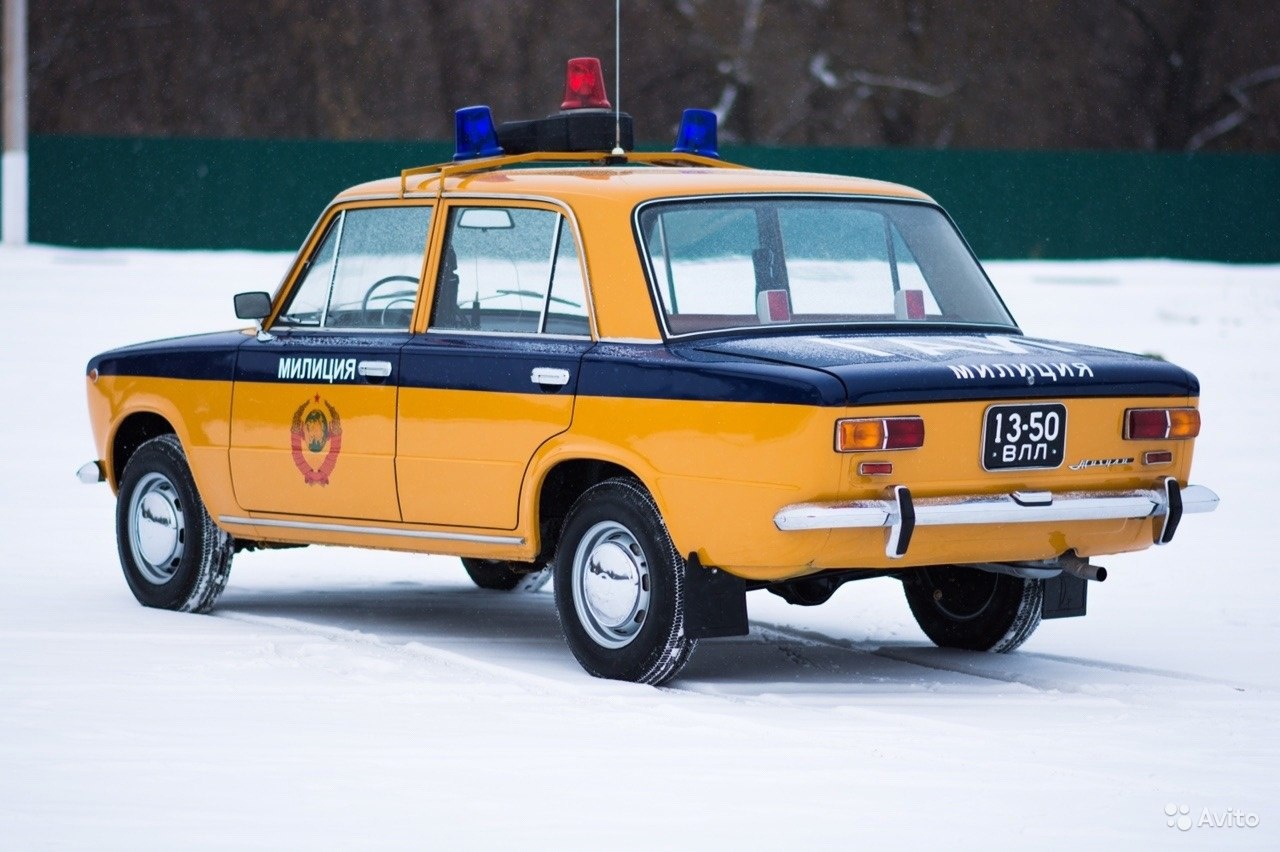 An orange Zhiguli police car.