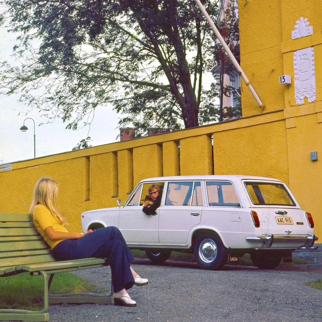 A man in a white Lada 2102 and a blonde girl.