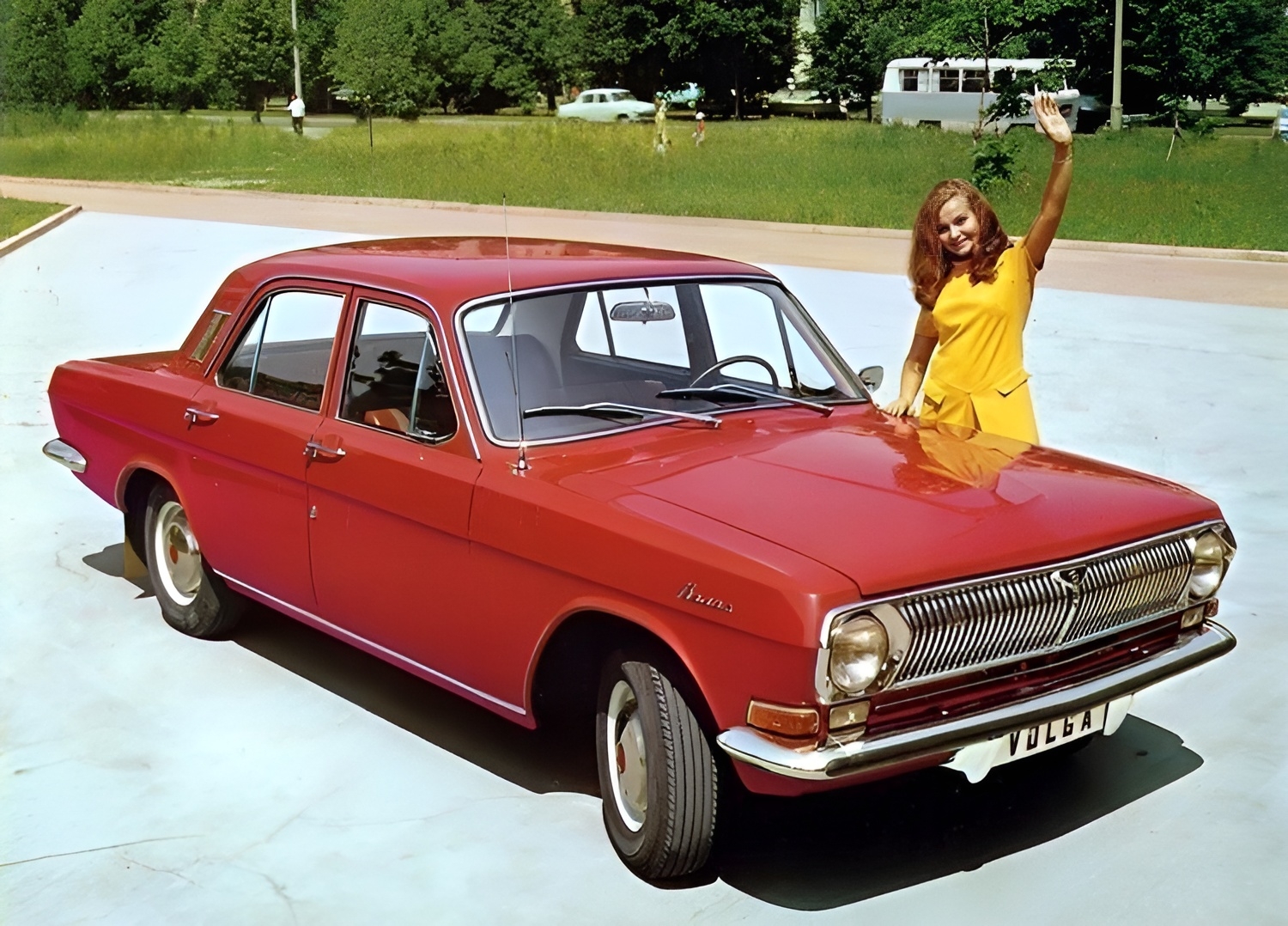 Russian Volga GAZ-24 owner happily waves at the camera.