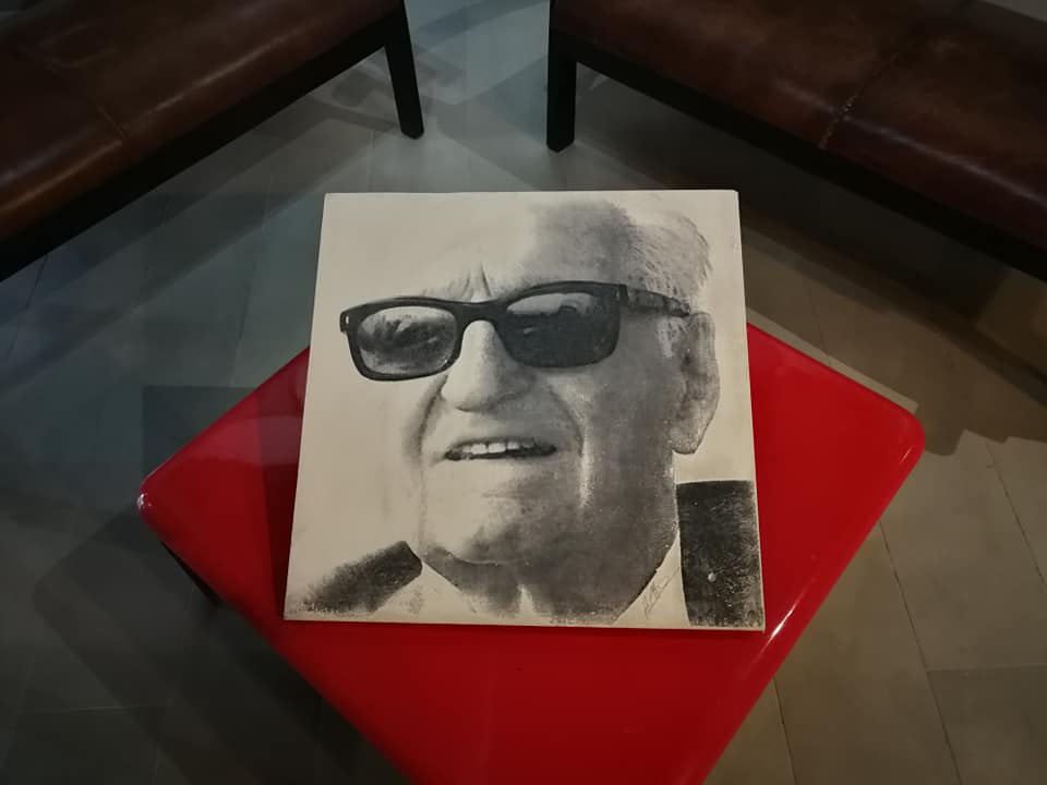 A photo of Enzo Ferrari displayed during an exhibition of Elis Sernesi's collection of scale Ferraris.