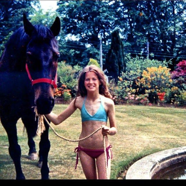 A young Kirsty Bertarelli with a black horse.