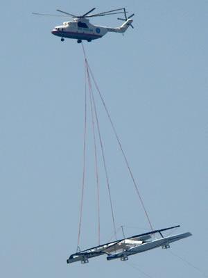 Alinghi transported by helicopter.