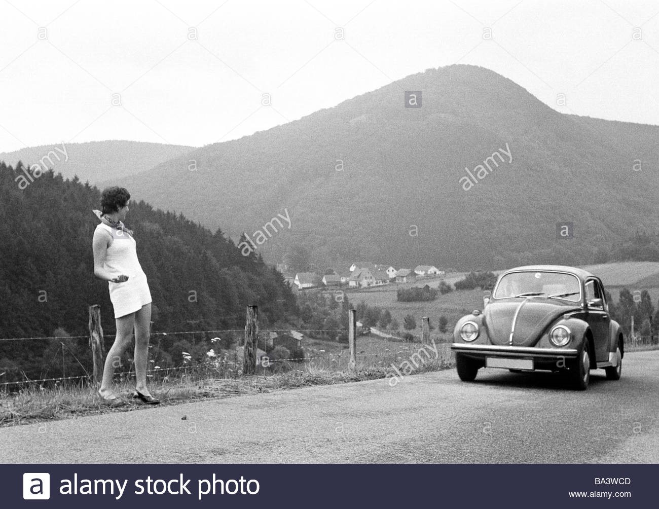 Seventies black and white photo holidays travel hitchhiker young girl.