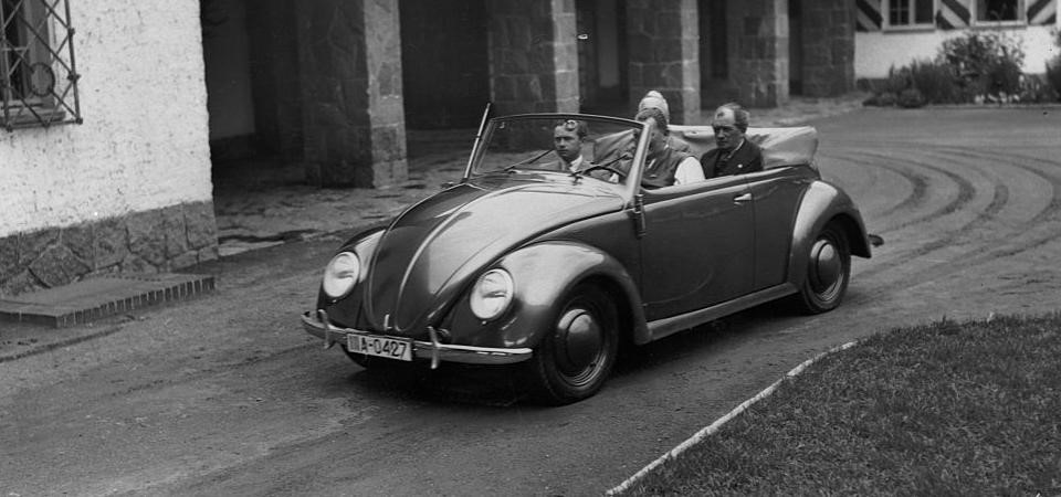 A 1939 Volkswagen Type 1 convertible, with Ferdinand Porsche in the back seat. 