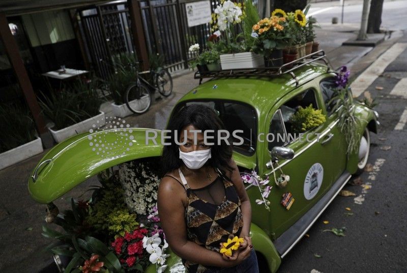 Valcineia Machado, also known as Roberta, poses by her car which she transformed to a mobile flower shop after losing her business amid the coronavirus disease (COVID-19) outbreak, in Rio de Janeiro, Brazil, October 8, 2020. Picture taken on October 8, 2020. 
