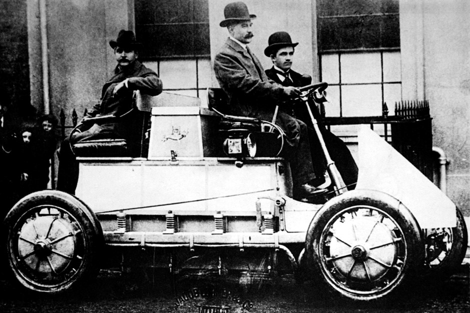 1900. First 4-wheel-drive car in the world. Ferdinand Porsche sitting next to the driver of a Lohner-Porsche Electromobile. It had four 1.8 kW motors. The vehicle was intended for competition use. Ferdinand himself delivered it to the purchaser, E.W. Hart in Luton, England. 