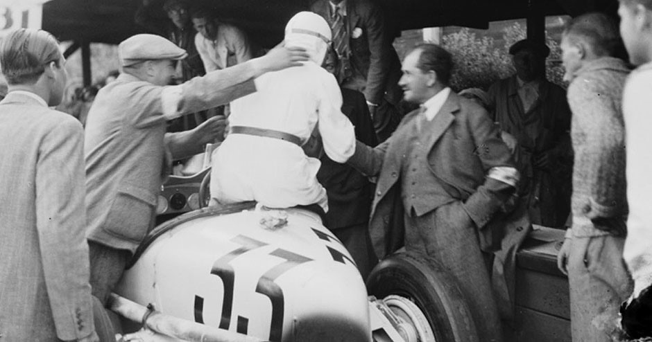 1932 May 22, AVUS race track. Ferdinand Porsche congratulating ex-Mercedes driver Rudolf Caracciola on the second position achieved with the Alfa Romeo 8C Monza. 