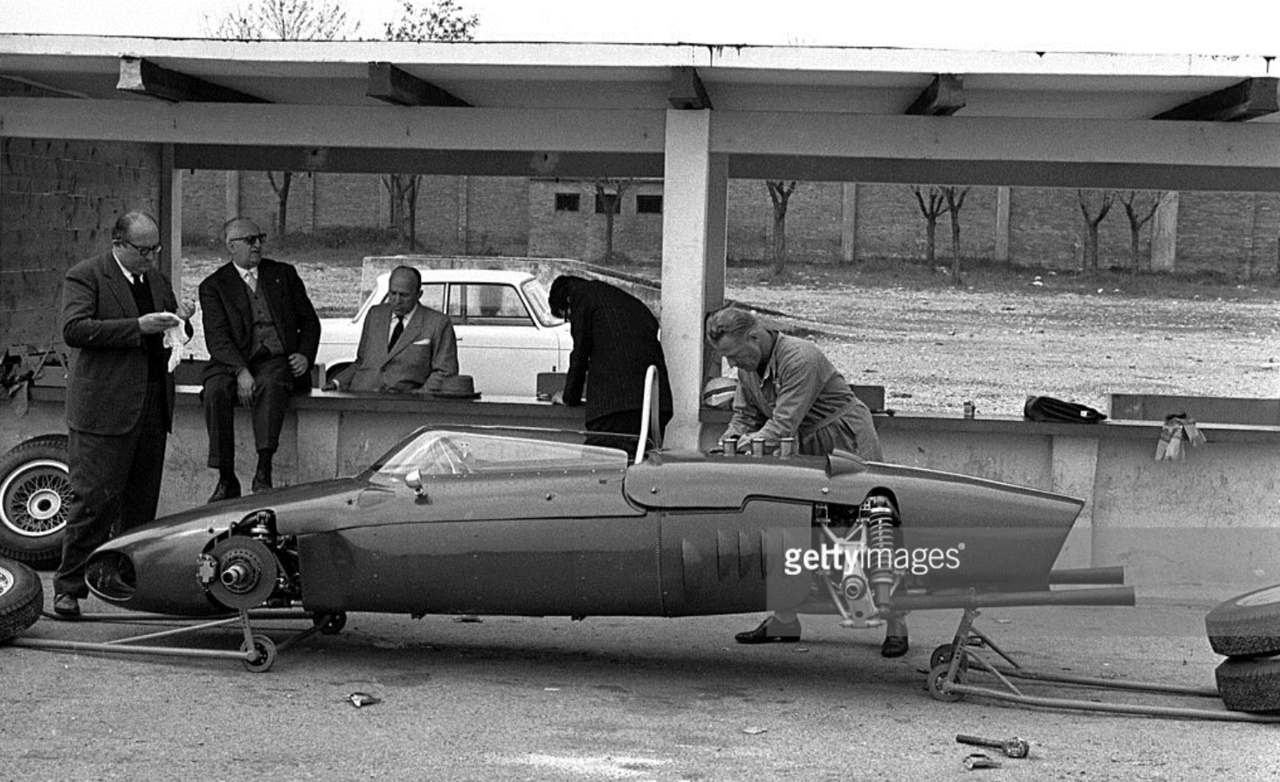 An earlier test than the one above, this chassis fitted with the 65 degree V6. Chiti is at left then the boss, another gent and copiously making notes is famous Ferrari engineer, Mauro Forghieri, then in his early days with the Scuderia.