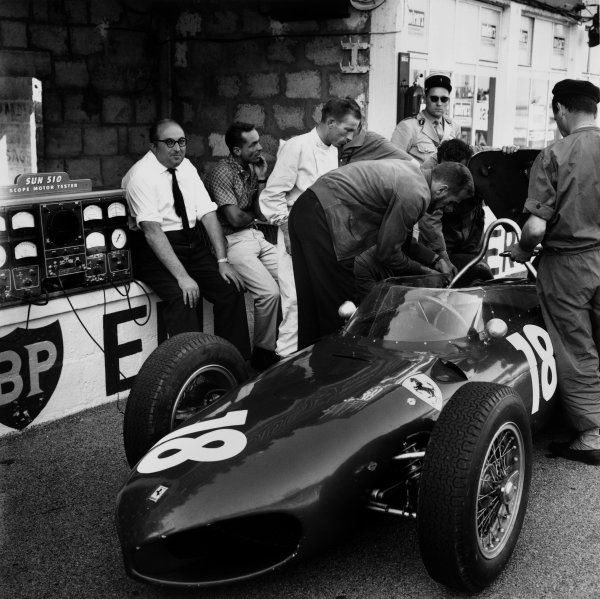 Reims, France, 30 June - 2 July 1961. Carlo Chiti, Ferrari engine designer, sitting on the pit wall with Phil Hill and Richie Ginther.