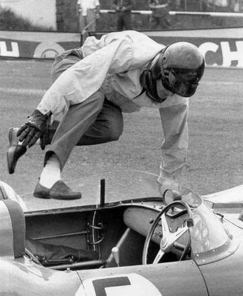 A vintage driver gets into his car.