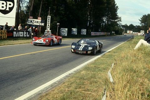 Bruce McLaren and Chris Amon’s #2 Ford Mk II opposite Richard Attwood and David Piper’s #16 Ferrari 365 P2 Spyder at the 1966 24 Hours of Le Mans. 