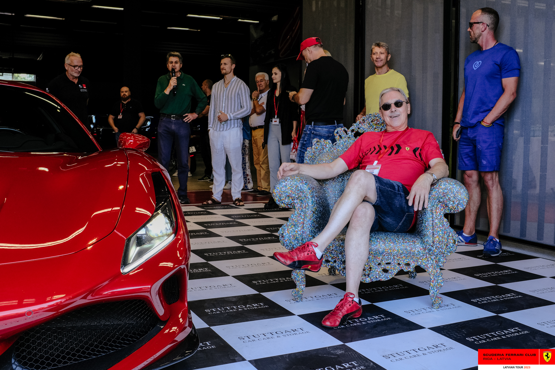 A red Ferrari and his owner ready to start the tour. 