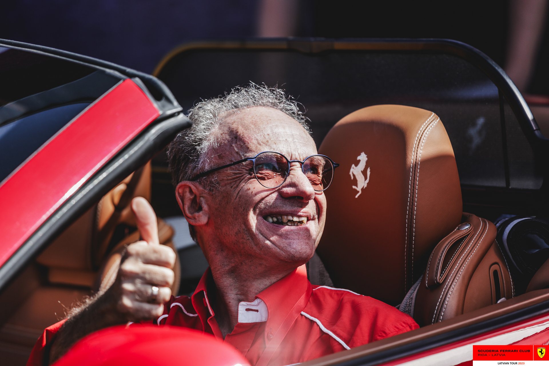 A Ferrari owner in his red Ferrari. 