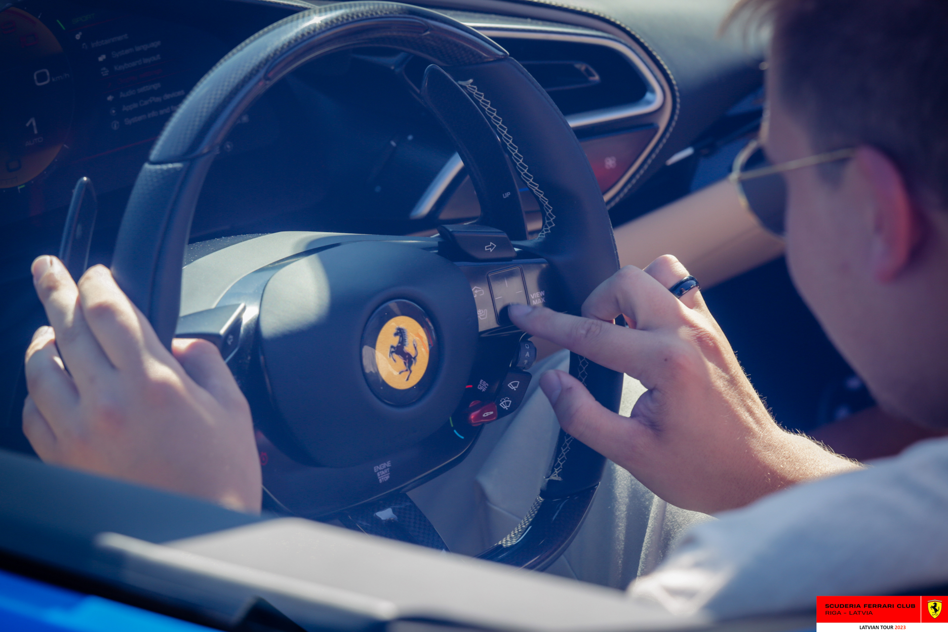 A Ferrari owner in his car. 