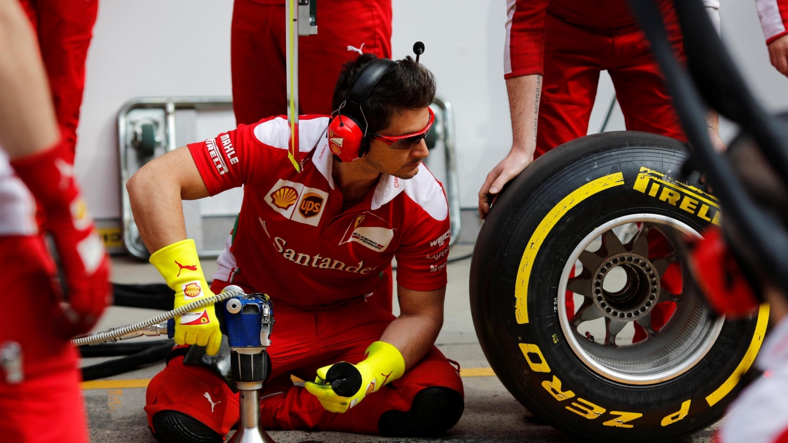 Mechanics and tyres in the Ferrari pits.