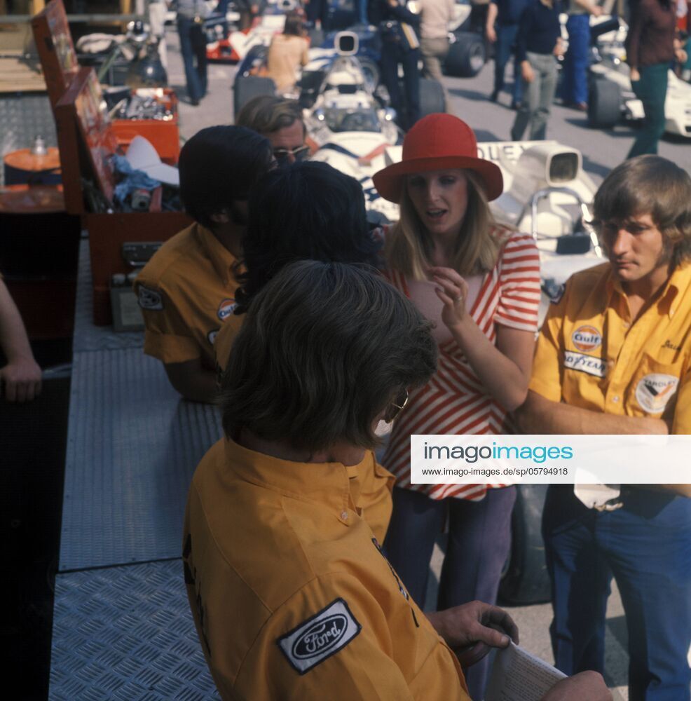 A pretty girl with McLaren mechanics in the pits at the Monaco GP on May 14, 1972.