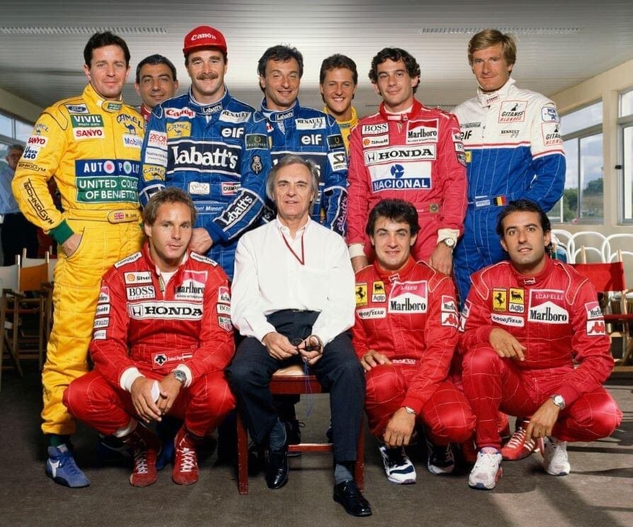 Group portrait of chief executive Bernie Ecclestone with Formula 1 drivers in their team colours in 1992. Back row: Martin Brundle, Michele Alboreto, Nigel Mansell, Riccardo Patrese, Michael Schumacher, Ayrton Senna and Thierry Boutsen. Front row: Gerhard Berger, Bernie Ecclestone, Jean Alesi and Ivan Capelli. 