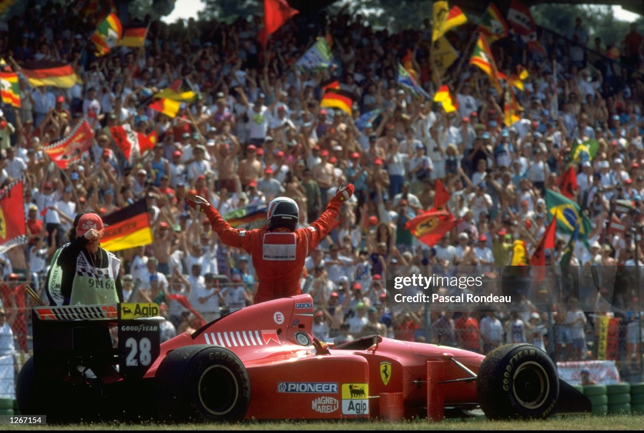 Gerhard Berger salutes the crowd as his Ferrari runs out of fuel on his victory lap after the German Grand Prix at Hockenheim on 31 July 1994. 